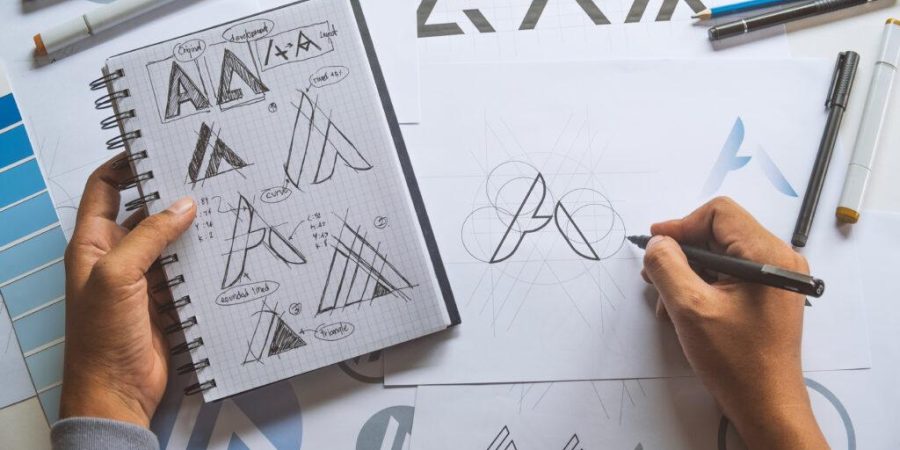 Graphic designer development process drawing sketch design creative Ideas draft Logo product trademark label brand artwork. Graphic designer studio Concept.